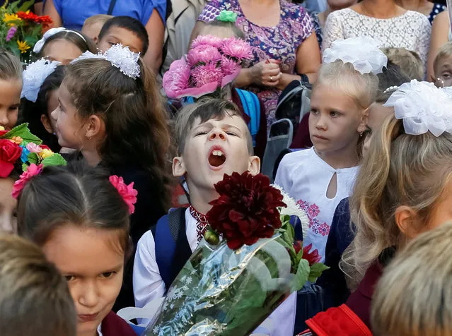 First graders attend a ceremony to mark the start of the school year in Kiev, Ukraine September 1, 2016. (Photo by Gleb Garanich/Reuters)
