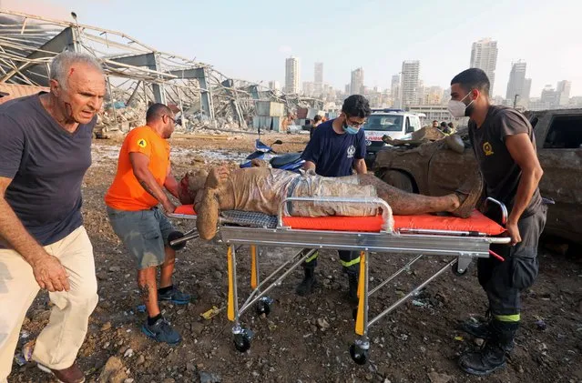An injured man who was pinned under a vehicle following an explosion in Beirut's port area, is transported on a stretcher to hospital, in Beirut, Lebanon, August 4, 2020. (Photo by Mohamed Azakir/Reuters/File photo)