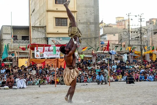 Wrestlers compete during a traditional Sindhi Malakhra wrestling during a local tournament in Karachi on November 24, 2022. (Photo by Asif Hassan/AFP Photo)