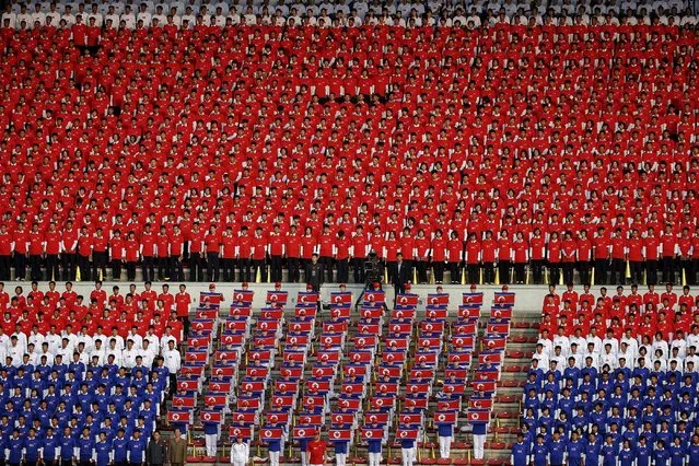 North Korean fans in national colours sing their national anthem before their team's preliminary 2018 World Cup and 2019 AFC Asian Cup qualifying soccer match against Philippines at the Kim Il Sung Stadium in Pyongyang October 8, 2015. (Photo by Damir Sagolj/Reuters)