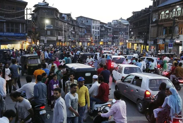 People crowd an open market in Lal Chowk, the central hub of business activity in Srinagar, the summer capital of Indian Kashmir, 12 September 2016. Markets opened in some places of Srinagar on the call of unified separatist leadership as people shopped ahead of the Muslim Eid-al-Adha holiday. Eid al-Adha is the holiest of the two Muslims holidays celebrated each year, it marks the yearly Muslim pilgrimage (Hajj) to visit Mecca, the holiest place in Islam. Muslims slaughter a sacrificial animal and split the meat into three parts, one for the family, one for friends and relatives, and one for the poor and needy. (Photo by Farooq Khan/EPA)
