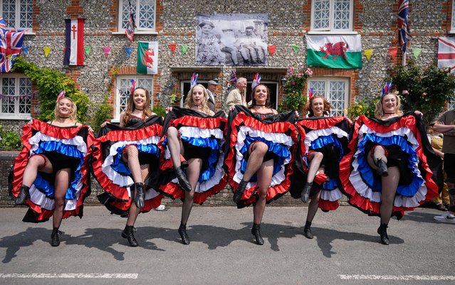 Members of The Butterflies event dancers perform a can-can dance in Southwick High Street during the Southwick Revival, a nostalgic event commemorating the D-Day Landings, at Southwick, Hampshire, UK on Sunday, June 8, 2025. (Photo by Andrew Matthews/PA Images via Getty Images)