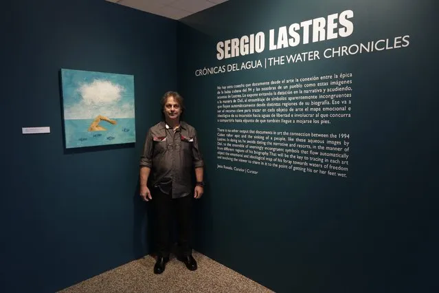 Former Cuban rafter Sergio Lastres, 49, poses at an exhibition of his work based on the 1994 Cuban raft exodus in Miami, September 19, 2014. Lastres and his wife were among 15 migrants rescued when their raft filled with water in 1994. They were taken to Guantanamo Base where he painted his first work about rafters, he said. (Photo by Rolando Pujol Rodriguez/Reuters)