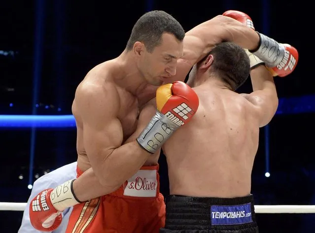 Ukrainian WBA, WBO, IBO and IBF heavyweight boxing world champion Vladimir Klitschko (L) delivers a punch to his challenger Bulgarian Kubrat Pulev during their title fight in Hamburg, November 15, 2014. (Photo by Fabian Bimmer/Reuters)