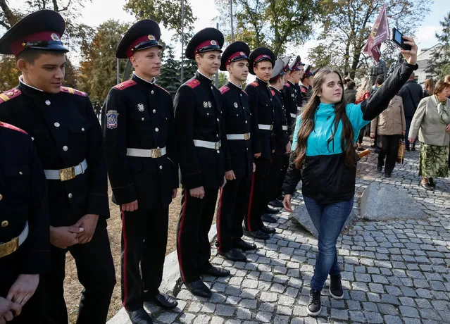 A woman takes a selfie with military cadets as they attend a Peace March to mark the International Day of Peace in Kiev, Ukraine, September 21, 2016. (Photo by Gleb Garanich/Reuters)