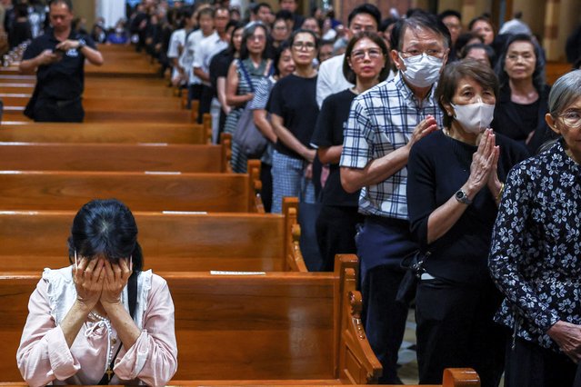 Catholic faithful react after Mass, following the death of Pope Francis, at the Assumption Cathedral, in Bangkok, Thailand, on April 22, 2025. (Photo by Chalinee Thirasupa/Reuters)