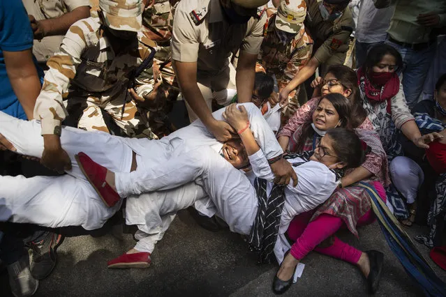 India's opposition Congress party supporters protesting against gang rape and killing of a woman in Uttar Pradesh’s Hathras district hold onto each other as Indian policemen try to detain them in New Delhi, India, Wednesday, September 30, 2020. The gang rape and killing of the woman from the lowest rung of India's caste system  has sparked outrage across the country with several politicians and activists demanding justice and protesters rallying on the streets. (Photo by Altaf Qadri/AP Photo)