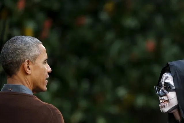 U.S. President Barack Obama looks at a boy in a costume during a Halloween trick-or-treating celebration on the South Lawn of the White House in Washington October 30, 2015. Invitees included local children and the children of military families, according to the White House. (Photo by Carlos Barria/Reuters)