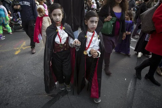 Children dressed as Dracula take part in the Children's Halloween day parade at Washington Square Park in the Manhattan borough of New York October 31, 2015. (Photo by Carlo Allegri/Reuters)