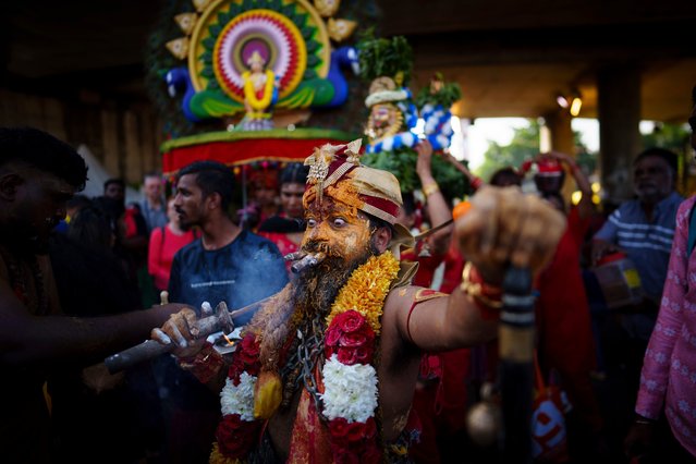 A Tamil Hindu priest has antiseptic powder on his face in a procession during the Thaipusam festival at Batu Caves, outskirts of Kuala Lumpur, Malaysia, Tuesday, February 11, 2025. (Photo by Vincent Thian/AP Photo)
