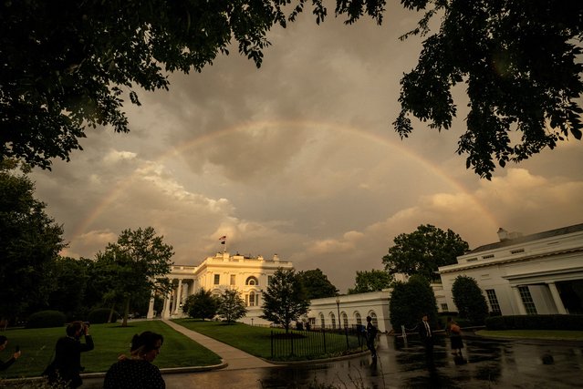A rainbow fills the sky behind the White House right after U.S. President Joe Biden and first lady Jill Biden greeted NATO allies and partners ahead of a dinner at the White House in Washington on July 11, 2024. (Photo by Ken Cedeno/Reuters)