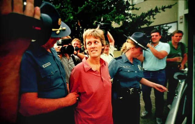 Elizabeth Diane Downs, the convicted childkiller who escaped July 11, 1987 from the women's prison in Salem, Ore., is escorted out of state police headquarters in Salem following  her capture July 21, 1987. Downs, convicted of killing one of her children and attempting to kill the other two, was transferred to a maximum-security prison in New Jersey. (Photo by Suzanne Vlamis/AP Photo)