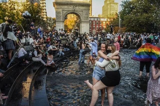 People stand in the fountain as they celebrate in Washington Square Park after it was announced that Democratic nominee Joe Biden would be the next U.S. President on November 7, 2020 in New York City. According to several news outlets presidential nominee Joe Biden has defeated incumbent U.S. President Donald Trump to become the 46th President of the United States. (Photo by Stephanie Keith/Getty Images)