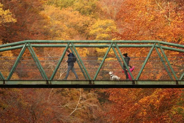 People walk on a bridge over river Garry, Pitlochry, Scotland, Britain on October 23, 2020. (Photo by Russell Cheyne/Reuters)
