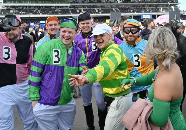 Racegoers dressed as jockeys attend the final day of the Cheltenham Festival at Cheltenham Racecourse, in Cheltenham, western England on March 17, 2023. (Photo by Glyn Kirk/AFP Photo)