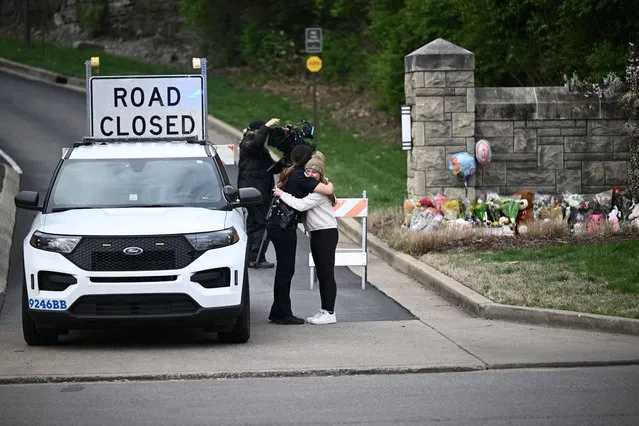 A woman hugs a police officer at the entrance of the Covenant School at the Covenant Presbyterian Church, in Nashville, Tennessee, March 28, 2023. A heavily armed former student killed three young children and three staff in what appeared to be a carefully planned attack at a private elementary school in Nashville on Monday, before being shot dead by police.
Chief of Police John Drake named the suspect as Audrey Hale, 28, who the officer later said identified as transgender. (Photo by Brendan Smialowski/AFP Photo)