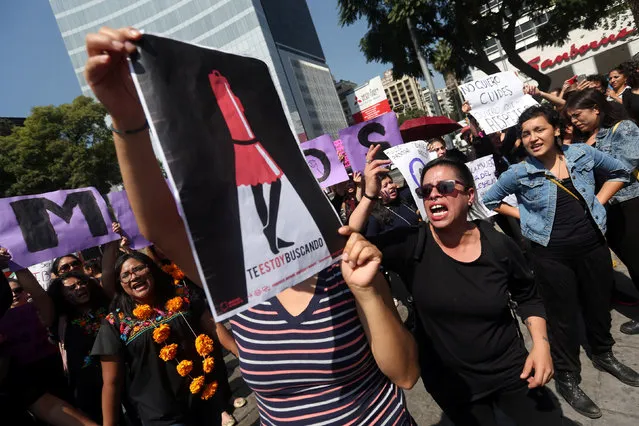 Activists block traffic to protest against violence against women, and of the murder of a 16-year-old girl in a coastal town of Argentina last week, at Angel de la Independencia monument, in Mexico City, Mexico, October 19, 2016. (Photo by Edgard Garrido/Reuters)