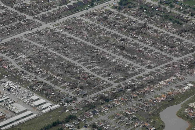 An aerial view of damage to neighborhoods in Moore, Oklahoma May 21, 2013, seen in the aftermath of a tornado which ravaged the suburb of Oklahoma City. Rescuers went building to building in search of victims and survivors picked through the rubble of their shattered homes on Tuesday, a day after a massive tornado tore through the Oklahoma City suburb of Moore, wiping out blocks of houses and killing at least 24 people. (Photo by Rick Wilking/Reuters)