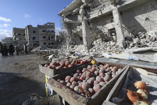 Produce are covered in dust as people inspect a site hit by what activists said were airstrikes carried out by the Russian air force on a busy market place in the town of Ariha, in Idlib province, Syria November 29, 2015. (Photo by Ammar Abdullah/Reuters)