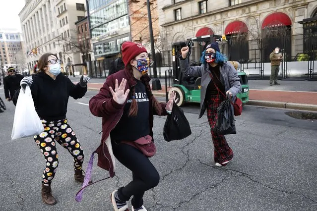 President Joe Biden supporters dance in the streets during 59th Presidential Inauguration, Wednesday, January 20, 2021, in Washington. (Photo by Rebecca Blackwell/AP Photo)