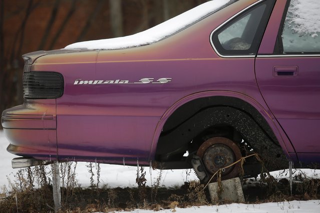 An older model Chevrolet SS Impala sits on a cinder block with a missing wheel in the backyard of an apartment building in Detroit, Michigan January 8, 2015. (Photo by Joshua Lott/Reuters)