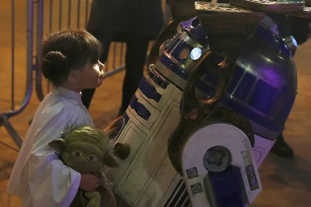 Audrey Mata from Washington D.C in the U.S. dressed as Princess Leia, comes face to face with a replica of R2-D2 at the  'For The Love of The Force' Star Wars fan convention in Manchester, northern England, December 4, 2015. (Photo by Phil Noble/Reuters)