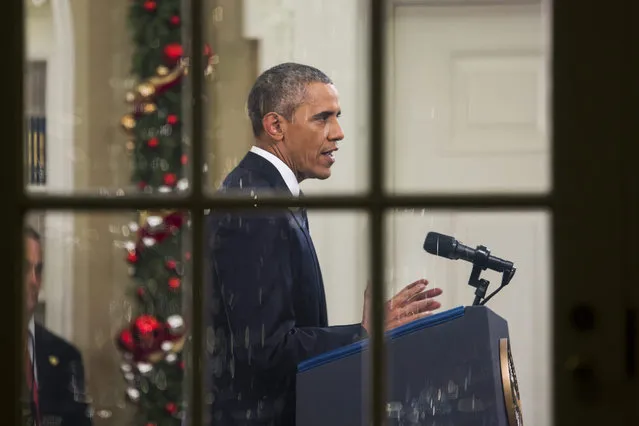 US President Barack Obama is seen through the window of the Oval Office delivering a rare, primetime address to the nation about the ongoing terror crisis and his plan to destroy the so-called Islamic State (IS or ISIS), in the White House, in Washington, DC, USA, 06 December 2015. This is only the third time that President Obama has spoken to the nation live from the Oval Office. (Photo by Jim Lo Scalzo/EPA)
