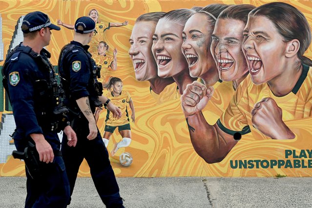 Police officers patrol near the Bondi Pavilion as life gradually returns to normal at Bondi Beach after the council cleared after the clean up of floral tributes following seven days of mourning, a week after the Bondi Beach shooting attack, in Sydney on December 22, 2025. (Photo by Saeed Khan/AFP via Getty Images)