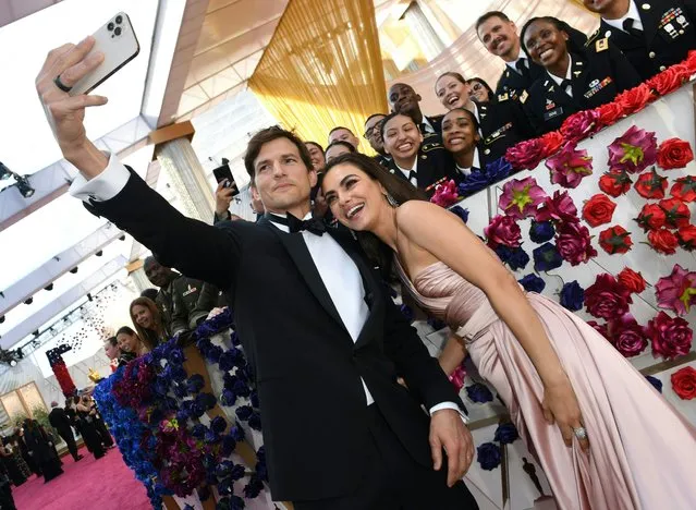 US actor Ashton Kutcher and actress Mila Kunis attend the 94th Oscars at the Dolby Theatre in Hollywood, California on March 27, 2022. (Photo by Valerie Macon/AFP Photo)