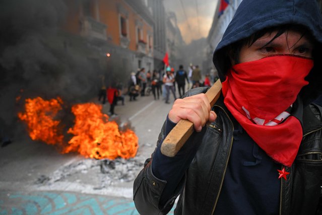 People protest against the extension of power cuts to 14 hours a day, the most restrictive measure taken by the government to face the worst drought in 60 years, in Quito on October 31, 2024.  (Photo by Rodrigo Buendia/AFP Photo)