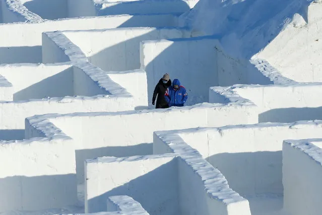People navigate through a giant snow maze, even larger than a similar maze build on the same site in 2019, which was proclaimed the world's largest by Guinness World Records, in St. Adolphe, Manitoba, Canada on February 19, 2021. (Photo by Shannon VanRaes/Reuters)