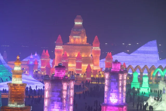 Tourists visit the 17th Harbin Ice And Snow World during its test run on December 22, 2015 in Harbin, China. (Photo by ChinaFotoPress/ChinaFotoPress via Getty Images)