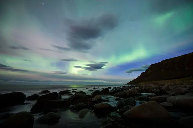 The northern lights, or aurora borealis, illuminate the sky over Flakstad beach on Lofoten Islands in the Arctic Circle on September 5, 2017. (Photo by Jonathan Nackstrand/AFP Photo)