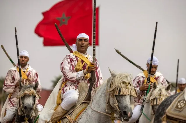 Moroccan horsemen ride during a performance to celebrate the annual Moussem festival in El Jadida on August 6, 2023. (Photo by Fadel Senna/AFP Photo)