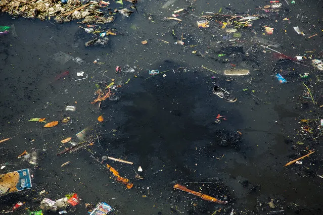 A thick black toxic stew bubbles up from the depths of the Citarum river on August 28, 2018 outside Bandung, Java, Indonesia. (Photo by Ed Wray/Getty Images)