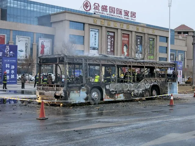 Firefighters are seen working inside a burnt bus after a fire on a street in Yinchuan, Ningxia Hui Autonomous Region, China, January 5, 2016. (Photo by Reuters/Stringer)