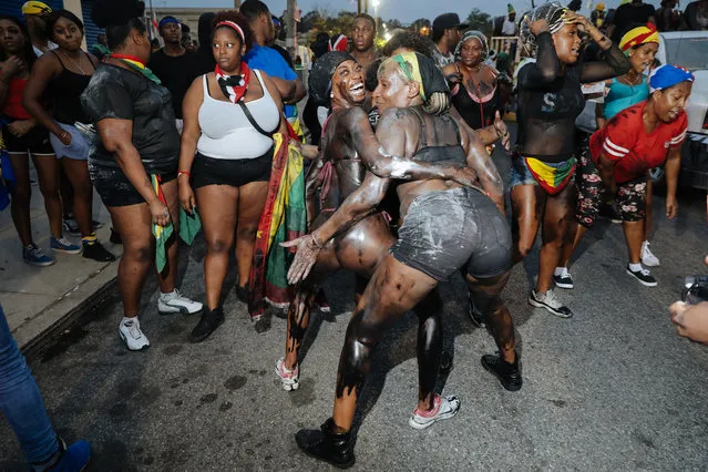 Revelers at dawn participate in J'Ouvert, an overnight celebration the night before the West Indies Day Parade in Brooklyn, NY on September 3, 2018. Violence in past years led NYPD to shut down the parade route until 2am. (Photo by Stephen Yang)