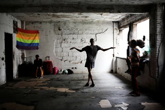 Members of lesbian, gay, bisexual and transgender (LGBT) community, that have been invited to live in a building that the roofless movement has occupied, spend time in the building, in downtown Sao Paulo, Brazil, November 3, 2016. (Photo by Nacho Doce/Reuters)