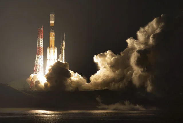 Japan's H-IIB rocket with a capsule called Kounotori, or stork, lifts off at the Tanegashima Space Center in Tanegashima, southern Japan, Friday evening, December 9, 2016. The Japanese capsule contains nearly 5 tons of food, water and other supplies, including new lithium-ion batteries for the International Space Station’s solar power system. (Photo by Ryosuke Uematsu/Kyodo News via AP Photo)