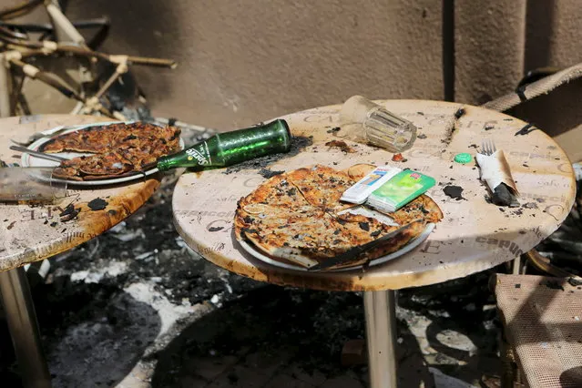 Pizzas are seen on the terrace of Cappuccino restaurant after an attack on the restaurant and the Splendid Hotel in Ouagadougou, Burkina Faso, January 18, 2016. (Photo by Joe Penney/Reuters)