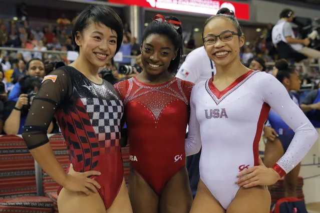 Bronze medalist Japan's Mai Murakami, left, gold medalist Simone Biles of the U.S., center, and silver medalist Morgan Hurd of the U.S., pose after their floor exercise on the second and last day of the apparatus finals of the Gymnastics World Championships at the Aspire Dome in Doha, Qatar, Saturday, November 3, 2018. (Photo by Vadim Ghirda/AP Photo)