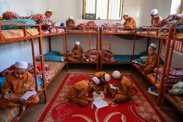 Afghan orphan boys study in their room at the Sheikh Zayed orphanage in Kandahar on September 19, 2023. (Photo by Sanaullah Seiam/AFP Photo)