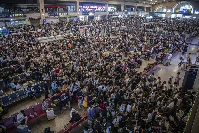 In this photo released by Xinhua News Agency, travelers prepare to catch their trains at the crowded Hankou Railway Station in Wuhan, central China's Hubei Province on Thursday, September 28, 2023. Tens of millions of Chinese tourists are expected to travel within their country, splurging on hotels, tours, attractions and meals in a boost to the economy during the 8-day autumn holiday period that began Friday. (Photo by Wu Zhizun/Xinhua via AP Photo)