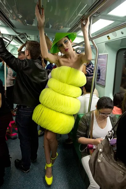 About 40 models participated in an event to promote Sao Paulo Fashion Week by riding the city's subways, on Oktober 27, 2013. (Photo by Andre Penner/Associated Press)
