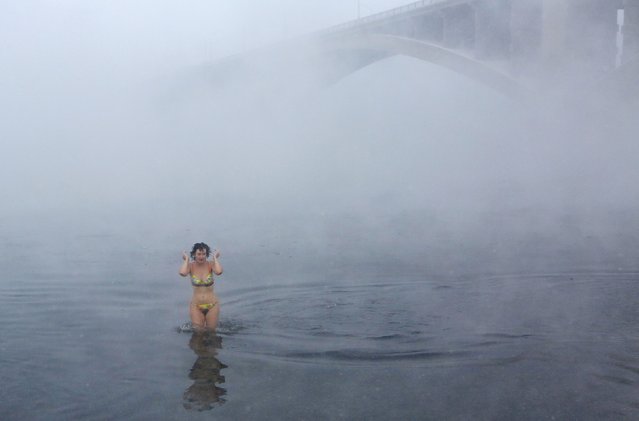 A member of the Cryophile amateurs winter swimmers club, takes a bath in the icy waters of the Yenisei River during the celebrations for the upcoming Christmas and New Year, with the air temperature at about minus 34 degrees Celsius (minus 29.2 degrees Fahrenheit), in Krasnoyarsk, Russia, December 24, 2016. (Photo by Ilya Naymushin/Reuters)