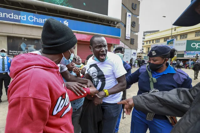 Kenyan activists (C) resist arrest from police officers, as police chased after activists from different social justice centers based in informal settlements, who were marching in protest against police brutality and harassment in their communities on Sab’a Sab’a day (or Seven-Seven), in Nairobi, Kenya, 07 July 2021. Police used tear gas to disperse the protestors and arrested several of them during the protest. The Sab’a Sab’a day commemorates protests and government crackdown on a multi-party democracy movement in the 1990’s. (Photo by Daniel Irungu/EPA/EFE)
