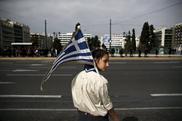 A girl scout holds a Greek national flag ahead of a student parade in Athens March 24, 2015, a day before a military parade to mark Greece's Independence Day. Greece said it will present a package of reforms to its euro zone partners by next Monday in hope of unlocking aid to help it deal with a cash crunch and avoid default. (Photo by Alkis Konstantinidis/Reuters)