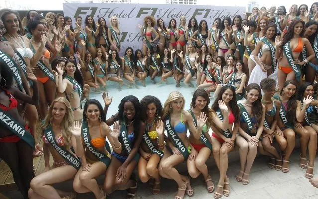 Miss Earth International 2013 beauty contestants pose for photographers at the pool of a hotel in Taguig city, Metro Manila on November 21, 2013. (Photo by Romeo Ranoco/Reuters)
