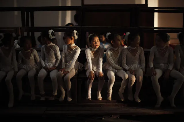 Girls sit backstage before their performance at a local school in Rason city, northeast of Pyongyang, August 29, 2011. (Photo by Carlos Barria/Reuters)