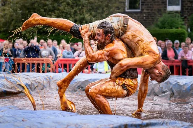 Competitors take part the World Gravy Wrestling Championships at the Rose “N” Bowl, in Rossendale, Lancashire on Monday, August 29, 2022. Contestants wrestle in the gravy for 2 minutes with points scored for fancy dress, comedy effect and wrestling ability, raising money for East Lancashire Hospice. (Photo by Danny Lawson/PA Images via Getty Images)